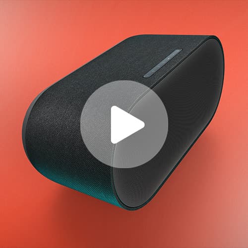 Black fabric-covered portable speaker with a tapered design and top control strip