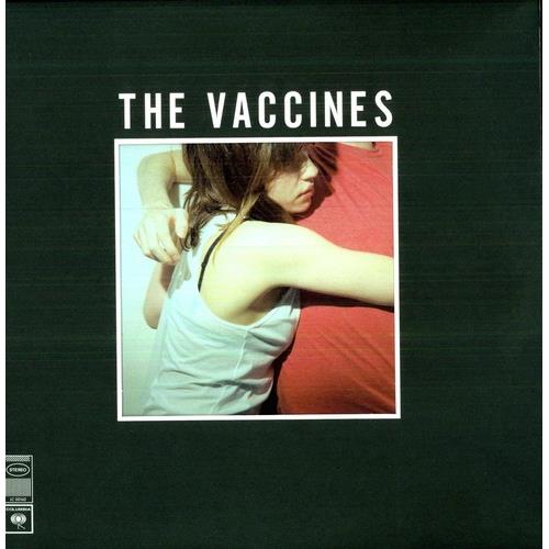 Dark green vinyl record sleeve with a central square photo of a woman in a white tank top