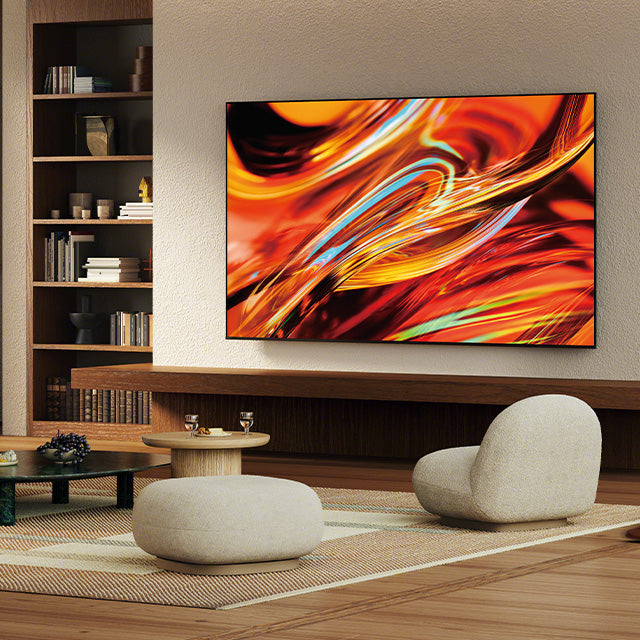 Wall-mounted flat-screen TV displaying vibrant orange and red abstract art in a modern living room