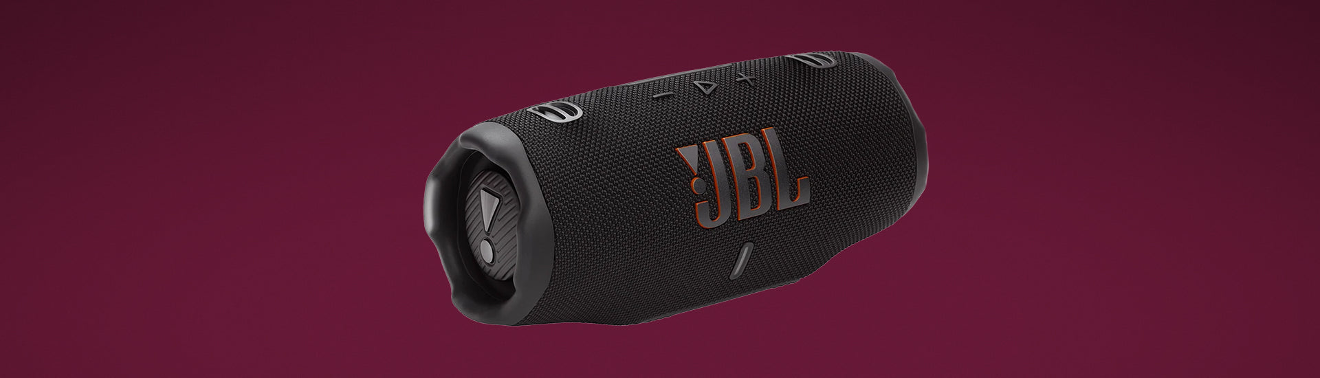 Black cylindrical portable speaker with woven mesh texture and orange JBL logo