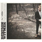 Vinyl LP cover featuring a man in a black suit standing in a wooded area