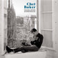 Black and white album cover featuring a man playing trumpet on a windowsill overlooking a cathedral
