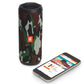 Cylindrical portable speaker with camouflage fabric grille and orange logo