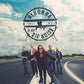 Vinyl LP cover featuring a band standing on an airfield runway beneath a vintage airplane logo