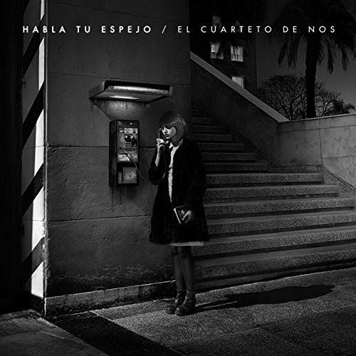 Black and white album cover showing a woman using a payphone at night