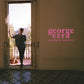 Album cover showing a man standing in an open doorway with pink text on the wall