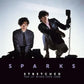 Album cover featuring two men in dark suits against a light background