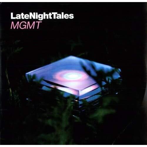 Black vinyl LP cover featuring a glowing translucent cube surrounded by dark foliage