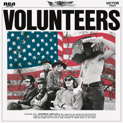Vintage rock album cover featuring a band posed in front of a distressed American flag backdrop