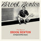 Black and white album cover featuring a man crouching beside a bus with red and black text below