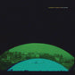 Green and blue album cover art featuring a silhouette of an airplane over a cityscape