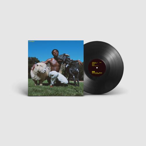Vinyl LP record with album cover showing a shirtless man kneeling in grass with two cows