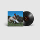 Vinyl LP record with album cover showing a shirtless man kneeling in grass with two cows