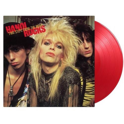 Translucent red colored vinyl record partially removed from album cover featuring three band members