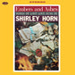 Vinyl LP cover with a yellow border featuring a stack of burned letters tied with a blue ribbon and 