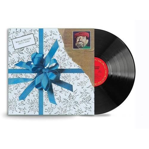 Vinyl record partially removed from a gift-wrapped sleeve with blue ribbon and floral pattern