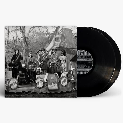 Black and white album cover featuring a band on a decorated stage with two black vinyl records