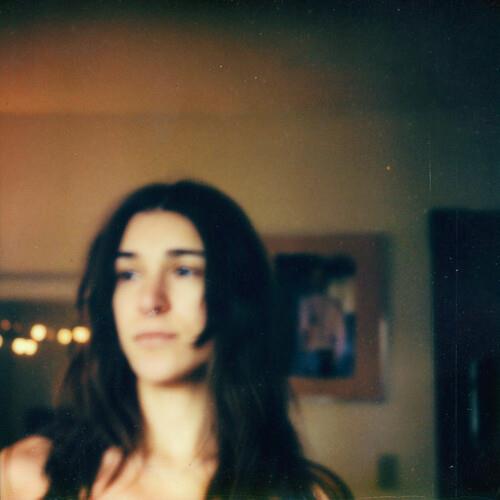 Vinyl LP cover featuring a soft-focus portrait of a woman with dark hair in a dimly lit room