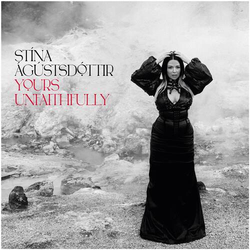 Black and white album cover featuring a woman in a black gown with puffed sleeves standing in a rock