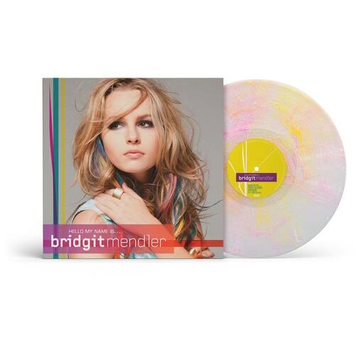 Clear vinyl LP with pink and yellow splatter pattern next to album cover featuring a woman with colo