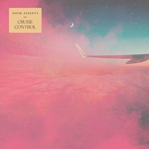Airplane wing over pink clouds with a crescent moon in a starry sky