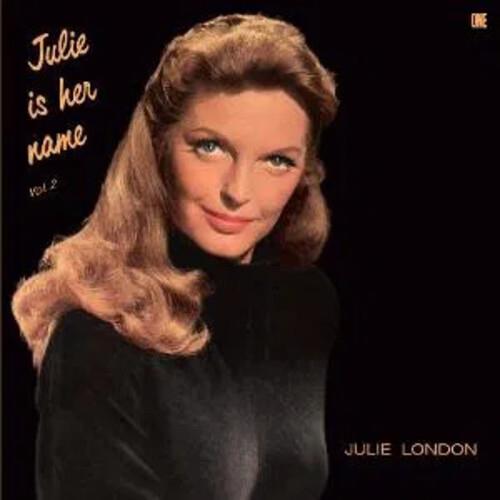 Portrait of a woman with wavy brown hair wearing a black turtleneck on a dark album cover