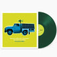Green vinyl record with album cover showing a blue truck with speakers on a yellow background