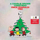Silver vinyl LP cover featuring Peanuts characters dancing around a decorated Christmas tree