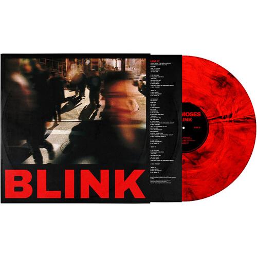 Red and black marbled vinyl record next to its album sleeve featuring blurred street photography