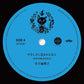 Light blue vinyl record label with black cat illustration and Japanese text