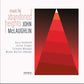 Album cover featuring a geometric red and orange triangle design on a black background