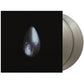 Silver colored vinyl record partially removed from black album sleeve featuring a single teardrop gr
