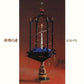 Ornate black wooden shrine with a central white pillar and blue fabric base