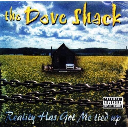 Album cover art featuring a small shack in a yellow field with a chain-link fence in the foreground