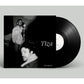Black vinyl record with a black and white sleeve featuring two men in a recording studio