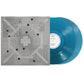Aqua colored vinyl record next to a gray album sleeve with geometric artwork