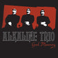 Black vinyl LP sleeve featuring three silhouetted figures in sunglasses against a red background wit