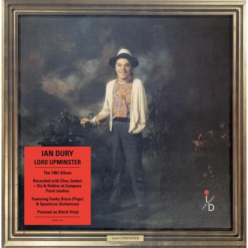 Framed album cover art featuring a man in a hat and cardigan standing in a garden setting