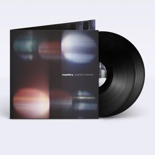 Black vinyl record partially removed from a dark gatefold sleeve with abstract blurred light pattern