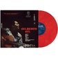 Red vinyl record partially removed from black album sleeve featuring a man playing guitar