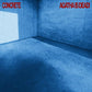 Blue concrete room with red text in the corners