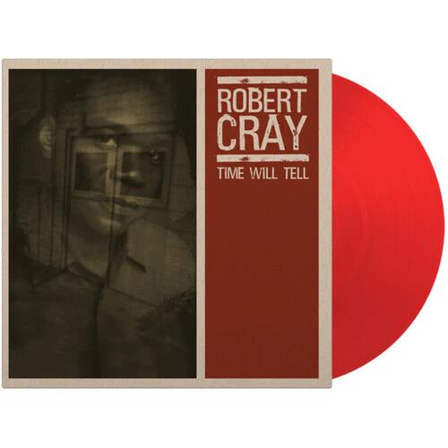 Translucent red colored vinyl record partially removed from a beige and red album sleeve featuring a