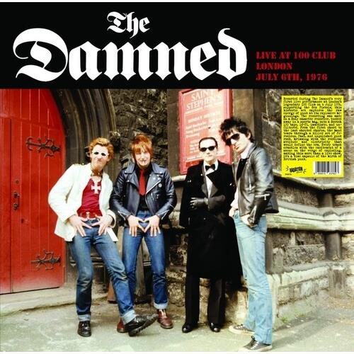 Four band members in leather jackets and sunglasses posing in front of a red door