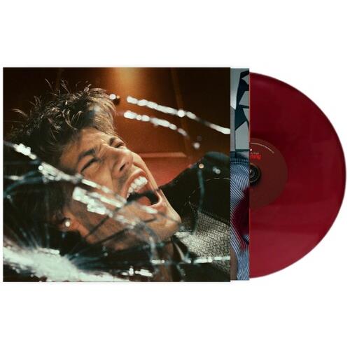 Red vinyl record partially removed from album sleeve featuring a man's face behind shattered glass