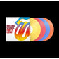 Four colored vinyl records fanned out next to a white album sleeve with a large tongue logo