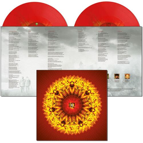 Red translucent vinyl records displayed with open gatefold sleeve featuring lyrics and a mandala-sty