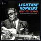 Black and white album cover featuring a man in sunglasses playing an acoustic guitar