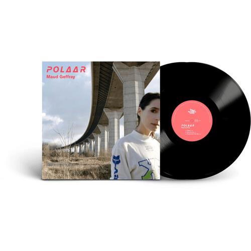 Black vinyl record with pink center label next to album cover featuring a woman under a concrete ove