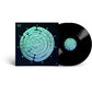 Black vinyl record with a dark album sleeve featuring a green and blue iridescent spiral design