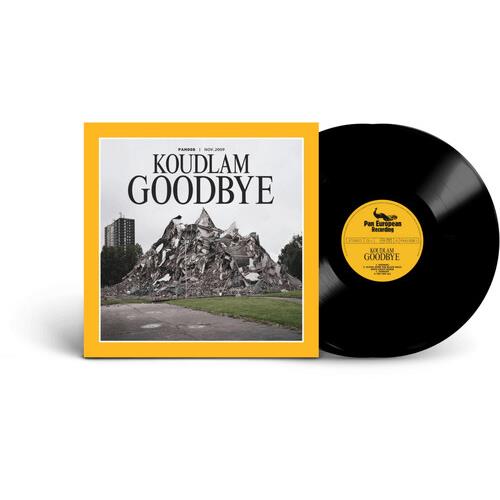 Yellow bordered album cover with a black and white photo of a rubble pile next to a black vinyl reco